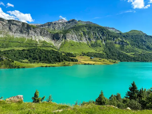 stock image Cormet de Roselend, lake with turquoise water, clouds and blue sky