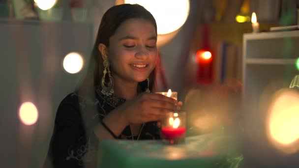 Lächelndes Hübsches Mädchen Mit Großen Ohrringen Sitzt Mit Kerze Bringen — Stockvideo