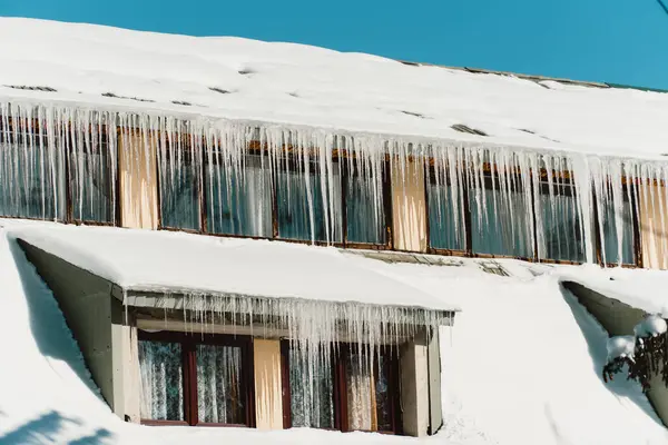 Ice covered windows of abandoned hotel