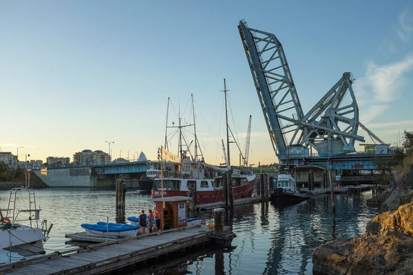 The iconic blue bridge or Johnson St. lift bridge is shown in the open position, before its eventual dismantlement in 2018.  Photographed in Victoria, British Columbia, Canada.