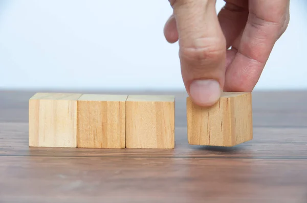 stock image Hand turning blank wooden cubes customizable space for text or ideas. Copy space.