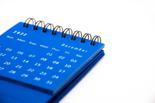 December 2022 blue desk calendar on white background with customizable space for text. Calendar concept.