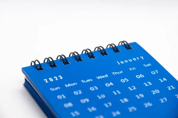 January 2023 blue desk calendar on white background with customizable space for text. Calendar concept.