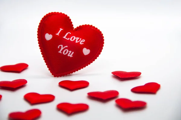I love you text on heart shape surrounded with other small heart shape on white cover background.