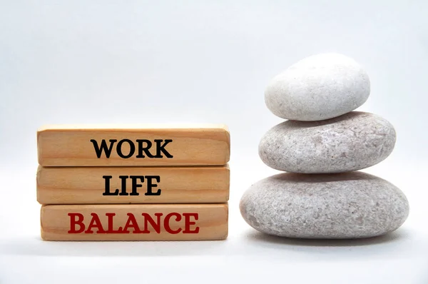 Work life balance text on wooden blocks with balanced zen stones. Working culture concept