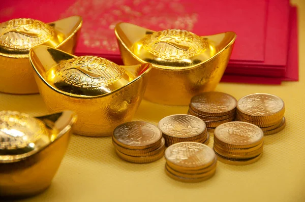 stock image Chinese New Year packets with Chinese Gold Ingots and gold coins on yellow background.