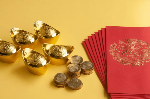 stock image Happy Chinese New Year concept - Red packets with Chinese Golden Ingots and coins on yellow background with customizable space for text.