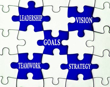 Business concept. Leadership, vision, goals, teamwork, and strategy text on missing jigsaw. clipart