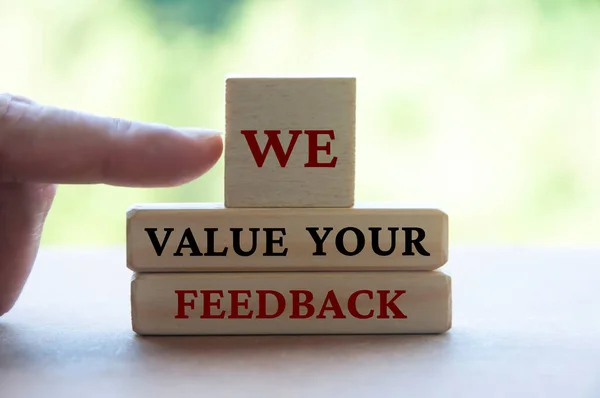 We value your feedback text on wooden blocks. Feedback concept