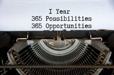 1 year 365 opportunities and opportunities words typed on an old vintage typewriter in black and white.