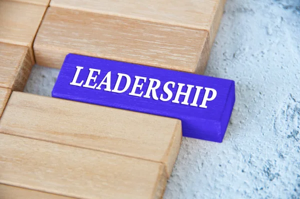 stock image Leadership text on blue wooden block separated from the rest of the blocks. Leadership concept.