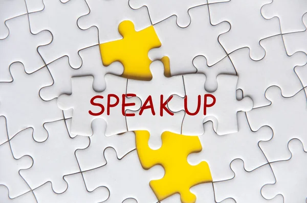 Speak Up text on missing jigsaw puzzle representing business culture in exercising rights to speak up.