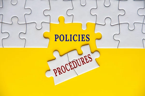 Policies and procedures text on missing jigsaw puzzle. Business policies concept.