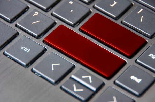 Side view of dark red key board with customizable space for text. Copy space.