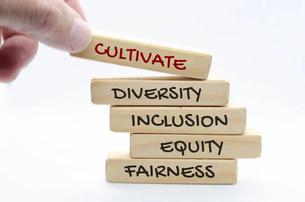 Cultivate diversity, inclusion, equity and fairness text on wooden blocks. Diversity concept