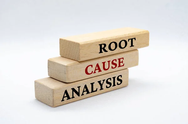 Root cause analysis text on wooden blocks.