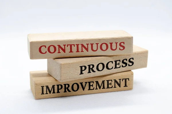 Continuous process improvement text on wooden blocks. Business culture and Operational excellence concept.