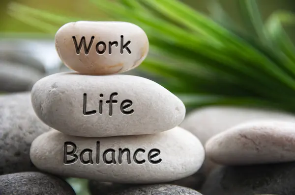 Work life balance text engraved on white stones. Work, lifestyle and life balance concept