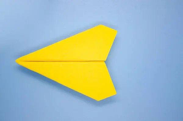 Top view of yellow airplane on light blue background with customizable space for text. Copy space and airplane concept