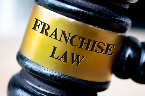 Franchise law text engraved on gavel. Franchise law and legal concept.