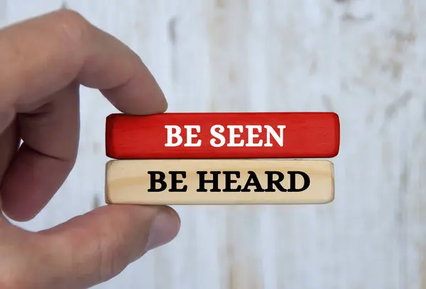 Be seen be heard text on wooden blocks. Business concept.