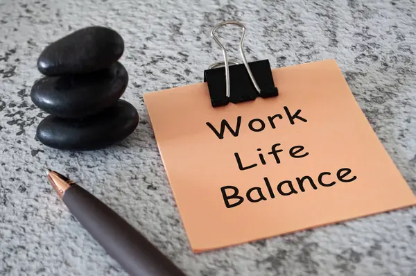 Work life balance text on sticky notes with pen and stack of zen stones. Life balance concept.