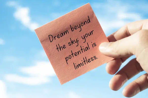 Motivational quote about dreaming beyond the sky on sticky note with sky background. Motivational concept.