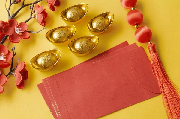 Chinese New Year red packet and golden ingot with customizable space for text or wishes. Chinese New Year celebration concept