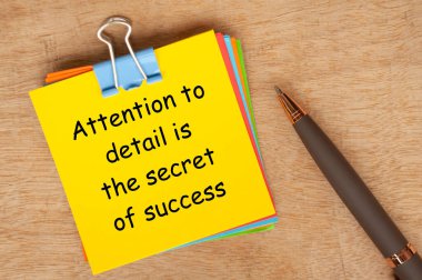 Attention to details is the secret of success text on yellow notepad. clipart