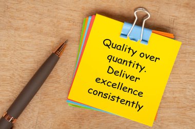 Quality over quantity. Deliver excellence consistently text on yellow notepad. Encouragement concept clipart