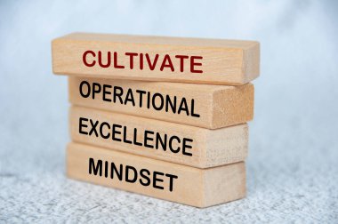 Cultivate operational excellence mindset text on wooden blocks. Operational excellence concept. clipart