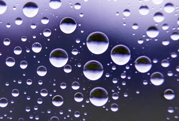 stock image Straight view of water droplets on clear glass on blurred nature background. Suitable for design and wallpaper