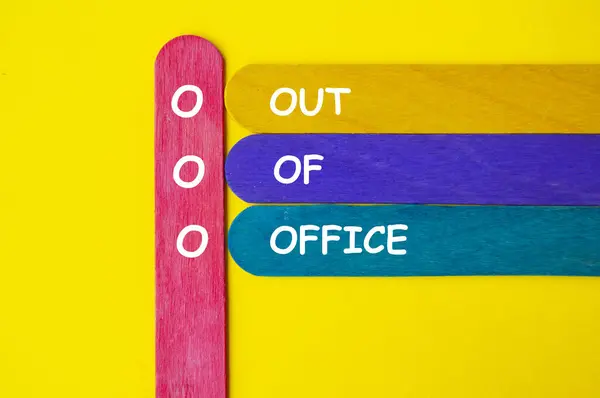 stock image Out Of Office text on multicolored wooden sticks. Out of office concept.