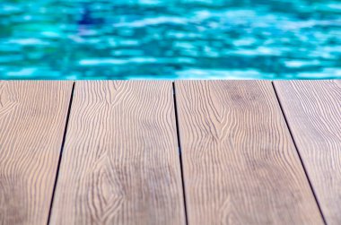 Wooden floor of swimming pool with customizable space for text or ideas. Vacation concept. clipart