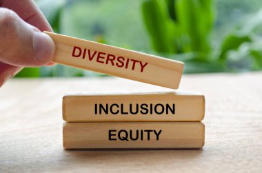 Diversity, Inclusion and Equity text on wooden blocks. D and I concept. clipart