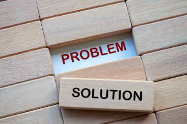 Problem and Solution text on wooden blocks representing problem solving business skill. Solution concept. clipart