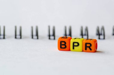 BPR representing Business Process Reengineering text on colorful plastic alphabet beads. Business concept. clipart