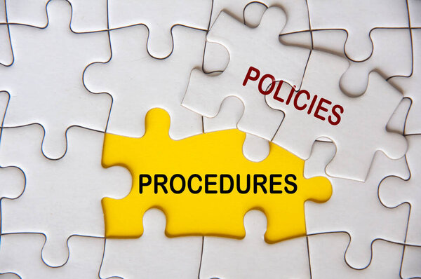 Top view of Policies and Procedures on white jigsaw puzzle. Policies and procedures concept.