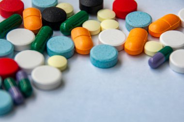 Renkli haplar ve kapsüller beyaz kapak arka planına dağılmış ve metin için özelleştirilebilir boşluk