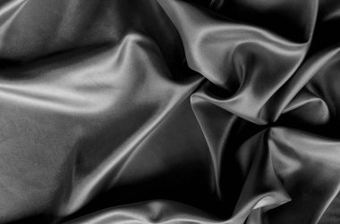 Koyu saten kumaşın üst görüntüsü, zengin dokuma ve pürüzsüz, zarif kıvrımlar. Tasarım ve duvar kağıdı arkaplanı için uygun.