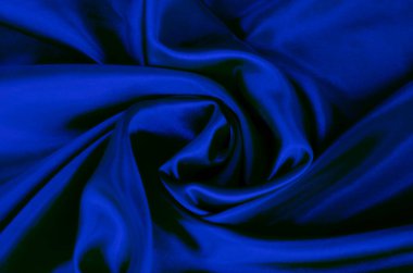 Tasarım ve duvar kağıdı arkaplanı için uygun ipeksi parıltılı koyu mavi ipek kumaş üst görünümü