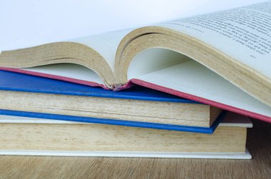 Close up of stake of books with customizable space for text