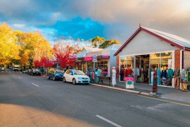 Adelaide Hills, Güney Avustralya - 24 Nisan 2021: Hahndorf Main caddesi manzarası Sonbahar sezonunda gün batımında mağazalar ve kafeler boyunca yürüyen insanlarla birlikte