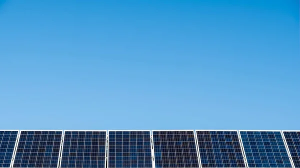 Solar panels on Australian business on a bright sunny day against blue sky