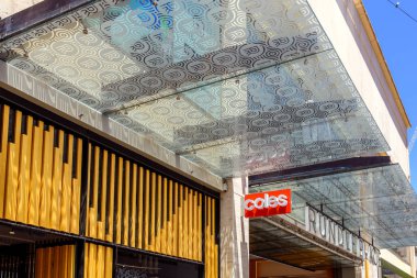 Adelaide, South Australia - December 28, 2022: Coles Supermarkets logo sign above entrance to Rundle Place shopping center in Adelaide CBD while viewed from Rundle Mall on a bright day clipart