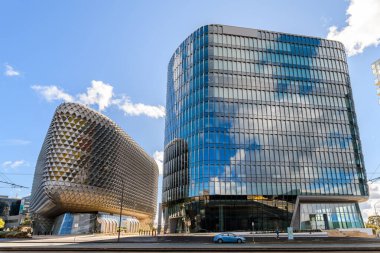 Adelaide, South Australia - July 14, 2024: Australian Bragg Centre for Proton Beam Therapy and Cancer Research and SAHMRI viewed from the North Terrace on a bright day clipart