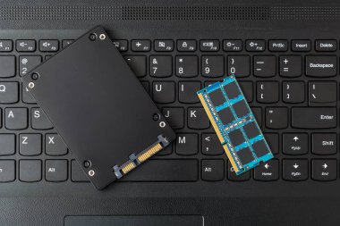 Klavyedeki bilgisayar RAM ve SATA SSD sürücüsünün kapalı görüntüsü. Dizüstü bilgisayar güncelleme kavramı