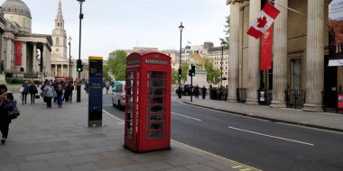 London, UK - May 16 2018: Red telephone booth near trafalgar square. It is one of the symbols of London