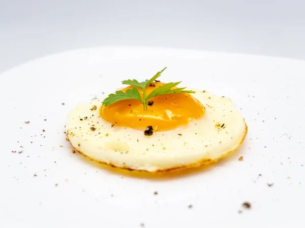 用欧芹装饰的盘子上的煎蛋 — 图库照片