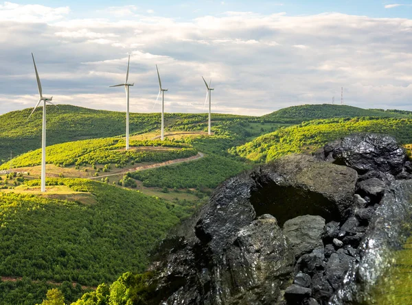 wind turbines and coal ore, energy transition concept